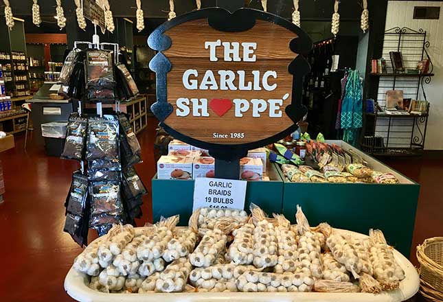 The Garlic Shoppe sign with garlic blubs near it