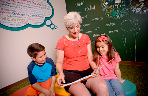 A grandmother reading to her grandchildren