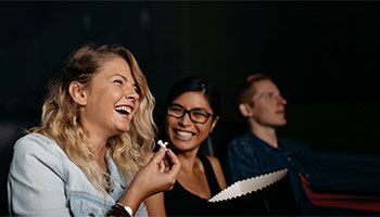 People laughing and eating popcorn