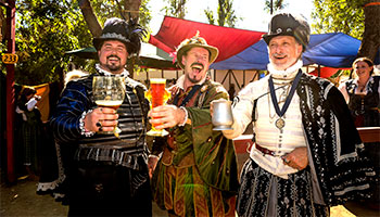 3 men happily drinking beer at the Renaissance Faire