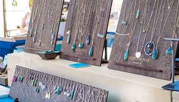 Jewelry with blue stones on brown wooden boards