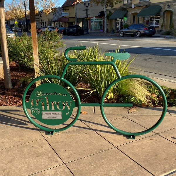 green bike rack with business in background