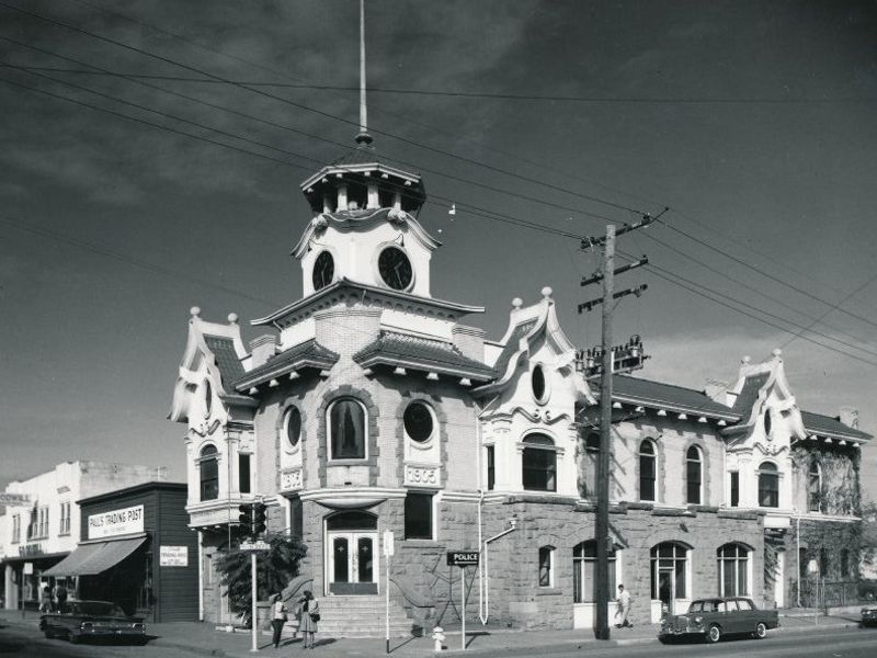 a black and white picture of Old City Hall in downtown Gilroy, with a Spanish Baroque style building with a large finial at the top