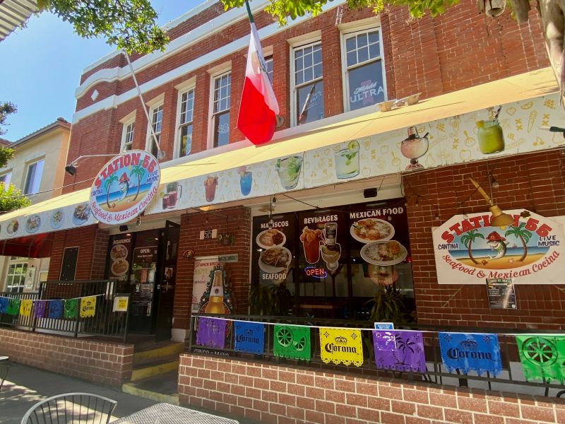 Station 55 Seafood & Mexican Cocina, a red brick building with white accents, a former fire house