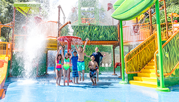 Children jumping and smiling in water at Gilroy Gardens Family Theme Park