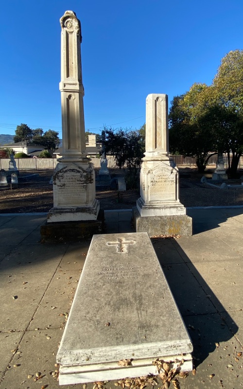 Three gravesites in a cemetery