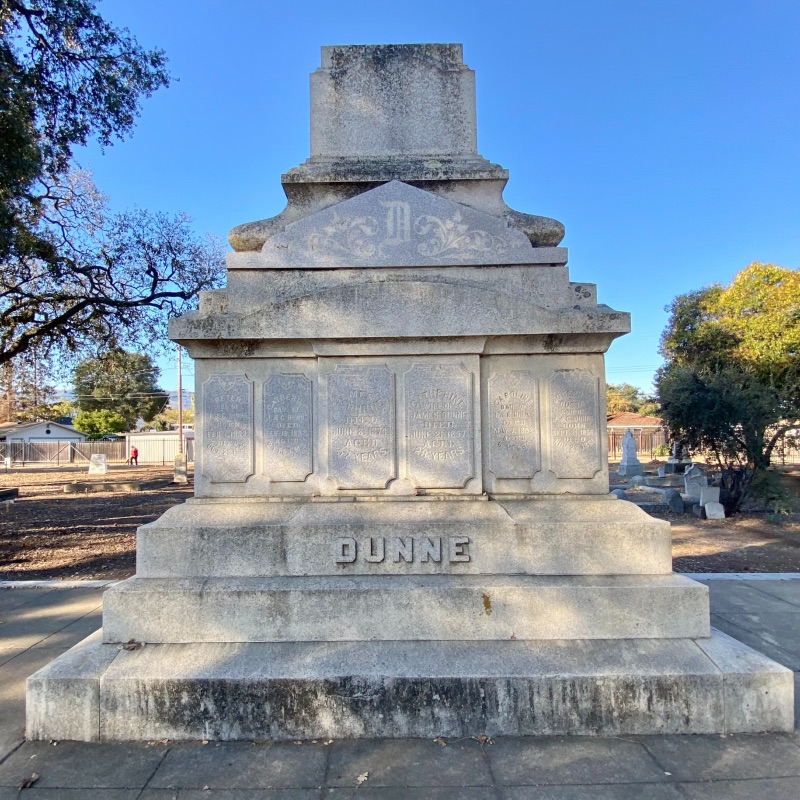 a large monument at a cemetery with the Dunne name on it