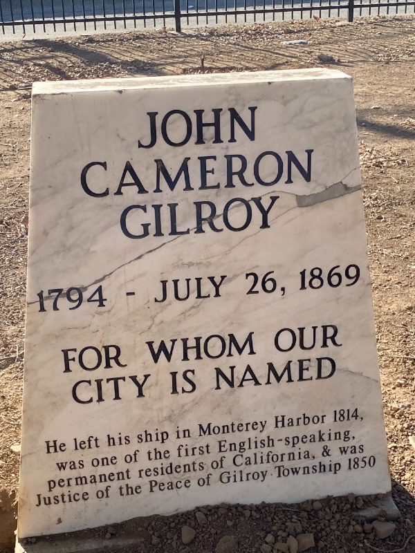 a marble grave monument with John Cameron Gilroy and his info. written on it in black