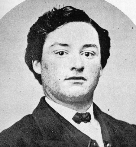 a black and white photo of a young man with dark hair