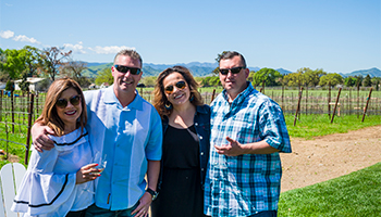 Two couples at Verde Vineyards holding wine glasses