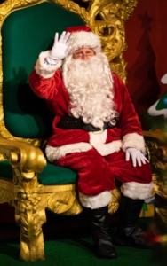Santa Claus sitting on a green and gold throne