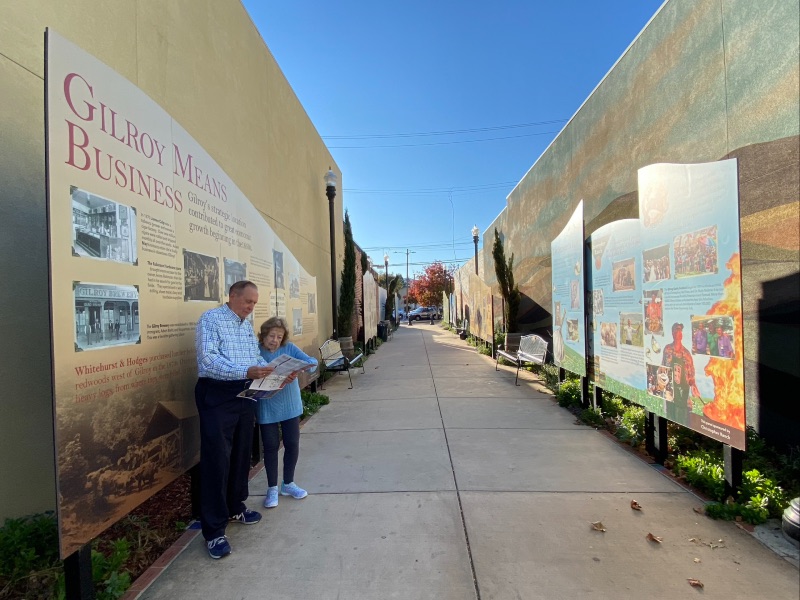 an older gentleman and woman reading a map while downtown in Gilroy on the Paseo