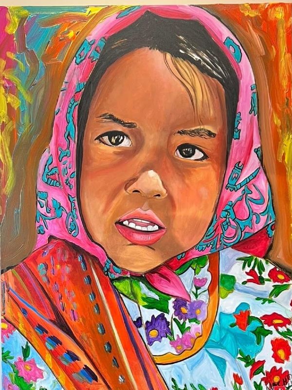 a little girl with brown skin and dark hair and eyes with a pink and blue headscarf and a floral dress