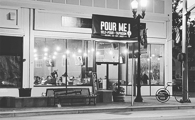 Black and white photo of the outside of Pour Me Taproom