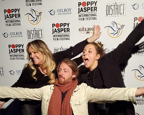 A man and two women very excited to be at the Poppy Jasper Film Festival