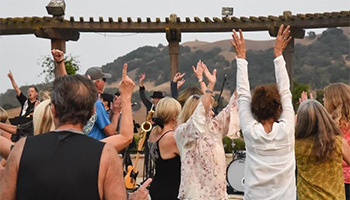 A group of people dancing at Clos la Chance winery with a live band