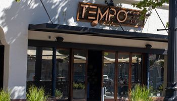 Tempo sign above glass doors with wooden frames